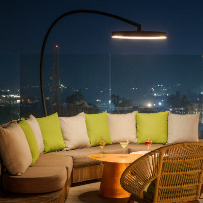 Bromic Eclipse Freestanding heater illuminating outdoor lounge seating at night