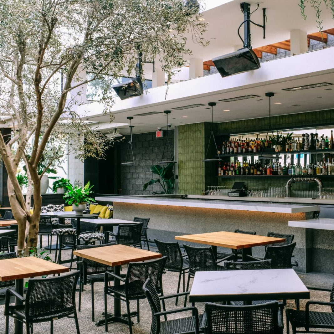 Restaurant patio with Bromic gas heaters on ceiling mounting poles